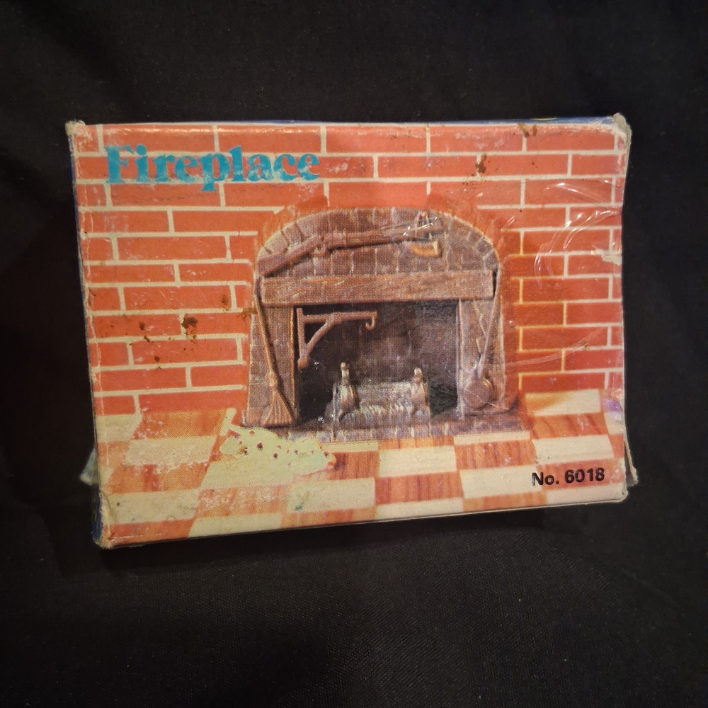 vintage die-cast metal miniature pencil sharpener styled as an antique fireplace